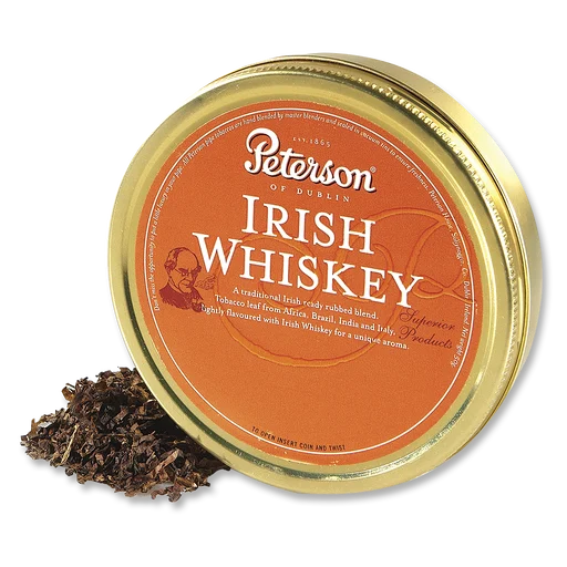 Tin of Peterson Irish Whiskey pipe tobacco with the lid off, showing loose ready-rubbed tobacco leaf spilling out beside the gold and orange tin
